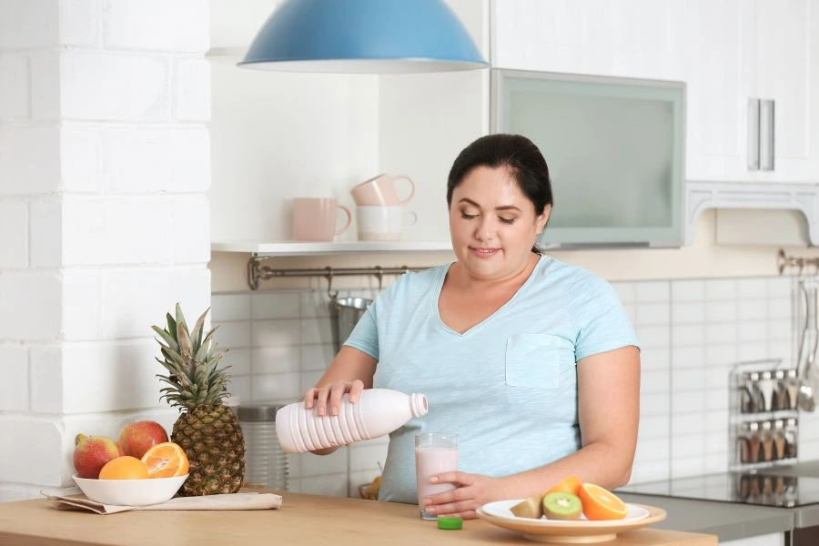 Woman pouring nutrition shake